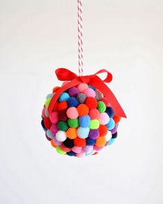 a colorful ball ornament hanging from a red string