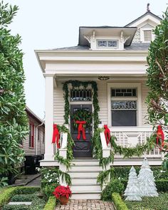 a house decorated for christmas with wreaths and decorations