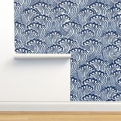 a blue and white wallpaper with an abstract design on the wall next to a wooden floor