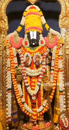 an idol is displayed in front of a wall