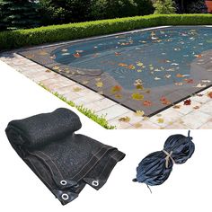 an in ground swimming pool with leaves on the ground and a netted cover over it