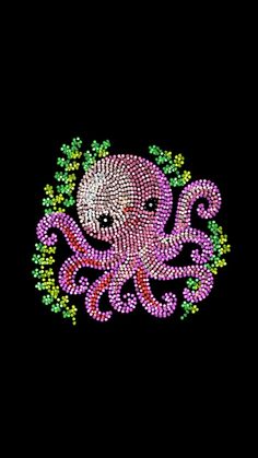 an octopus with pink and green beads on it's face is in the middle of a black background