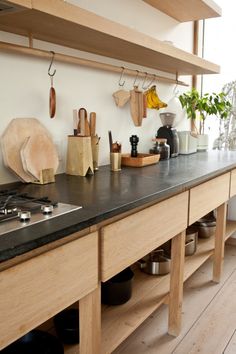 a kitchen counter with pots and pans on it