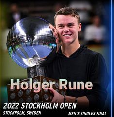 a young man holding up a trophy in front of him with the words holder rune on it