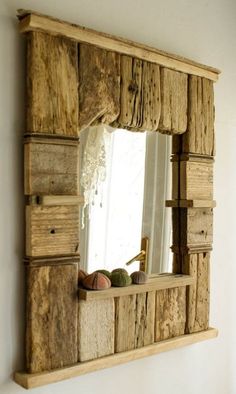 a mirror that is made out of wooden planks and has some fruit in it