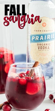 a glass filled with cranberry sangria on top of a table