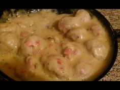 a skillet filled with meatballs covered in gravy