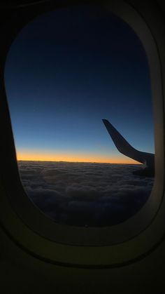 the view from an airplane window at sunset