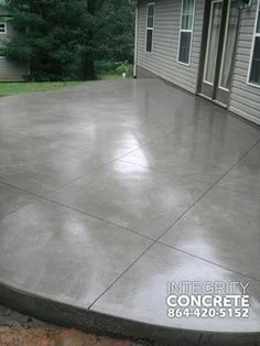 a concrete patio being built in front of a house