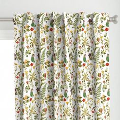 the curtains are decorated with colorful flowers and plants on them, along with white walls