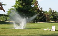 a man hitting a golf ball with a club