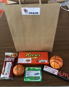 an assortment of snacks sitting on top of a table next to a brown paper bag