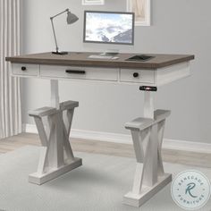 a desk with a computer on top of it in front of a window and white rug