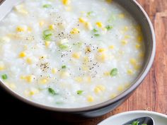 a bowl of soup with corn on the side