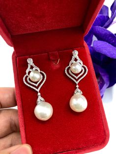 We are presenting you a HUGE pair of CHANDELIER, Genuine, PURE White South Sea Pearls, extremely FINE A+, LUSTROUS and Rare! Accenting the 4 pearls are 136 pieces of E/VS Natural diamonds, weighting a total of 1.62 carats. Set in fabulously designed 18K solid white gold earrings ONLY ONE ITEM AVAILABLE!! NO DUPLICATES!! WHAT YOU SEE IN THE PICTURES IS WHAT YOU WILL GET SOLIDLY HANDCRAFTED EARRINGS! SUGGESTED RETAIL VALUE: $10,880 PEARLS: Size: Bottom Pair 14 x 15 mm, Top Pair 11 mm. Shape: Round Luxury Drop Bridal Earrings With Elegant Design, Luxury Drop Earrings Bridal With Elegant Design, Luxury Drop Earrings With Elegant Design For Bridal, Luxury Drop Earrings With Elegant Design, Luxury Pearl White Dangle Pearl Earrings, Luxury Drop Pearl Earrings For Formal Occasions, Luxury Drop Pearl Earrings For Formal Events, White Pear-shaped Pearl Earrings With Elegant Design, Elegant White Pear-shaped Pearl Earrings