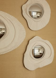 two mirrors that are on the side of a wall