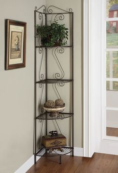 a corner shelf with some plants and other items on it in a living room area