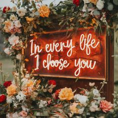 a sign that says the every life i choose you on it with flowers around it