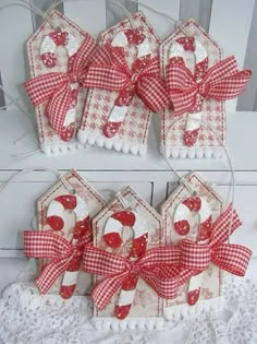 some kind of gift tags that are made out of fabric and paper with hearts on them