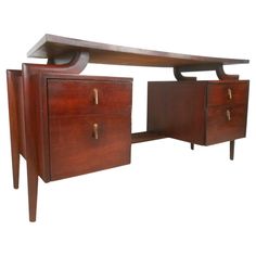 a wooden desk with two drawers on one side and a shelf on the other end