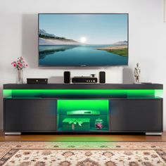 a flat screen tv sitting on top of a entertainment center