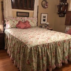 a bed sitting in the middle of a bedroom next to a window with curtains on it