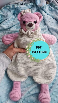 a crocheted pink teddy bear laying on top of a blue blanket with the words pdf pattern