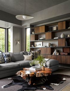 a living room filled with furniture and lots of windows