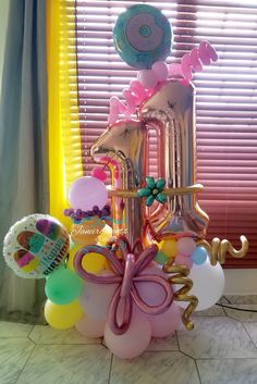 a balloon tower with balloons and decorations on it