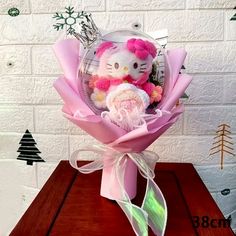 a hello kitty bouquet is sitting on a table