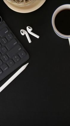 a keyboard, mouse and coffee cup on a table