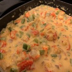 some food is cooking in a skillet on the stove top and ready to be eaten