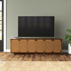 a flat screen tv sitting on top of a wooden cabinet