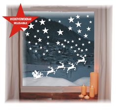 the window is decorated with white stars and santa's sleigh