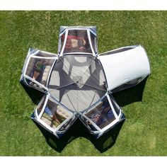 an upside down view of the inside of a tent with pictures in it on grass