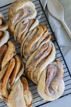 several cinnamon rolls sitting on top of a cooling rack