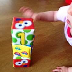 a baby playing with a toy on the floor