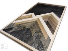 three wooden frames with trees and mountains on the bottom one is made out of wood