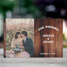 a wooden photo album with the words our wedding printed on it and an image of a bride and groom