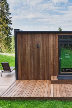 a wooden deck with a chair next to it and a large poster on the wall