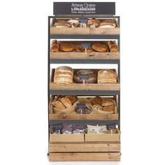 an assortment of breads and pastries on display in a wooden crate with labels