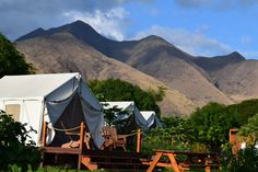 tents are set up in front of mountains