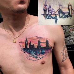 a man's chest is covered with tattoos and has a skyline tattoo on it