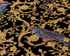 two birds sitting on top of a gold and black wallpaper covered in flowers, vines and leaves