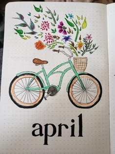 an open notebook with a drawing of a bicycle and flowers in the basket on it