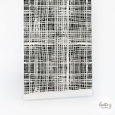 a black and white wall hanging on the side of a wall