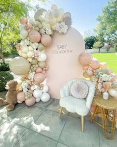 a baby shower is set up with balloons and flowers