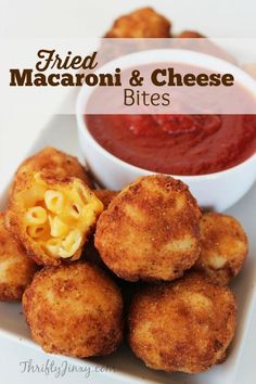 fried macaroni and cheese bites on a plate with tomato sauce in the background