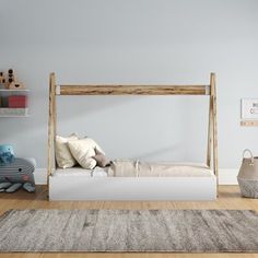 a white bed sitting on top of a wooden floor