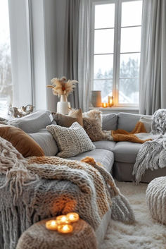 a living room filled with lots of furniture next to a large window covered in blankets